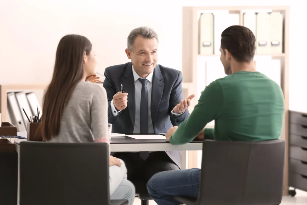 An Attorney Speaking With A Couple In His Office.